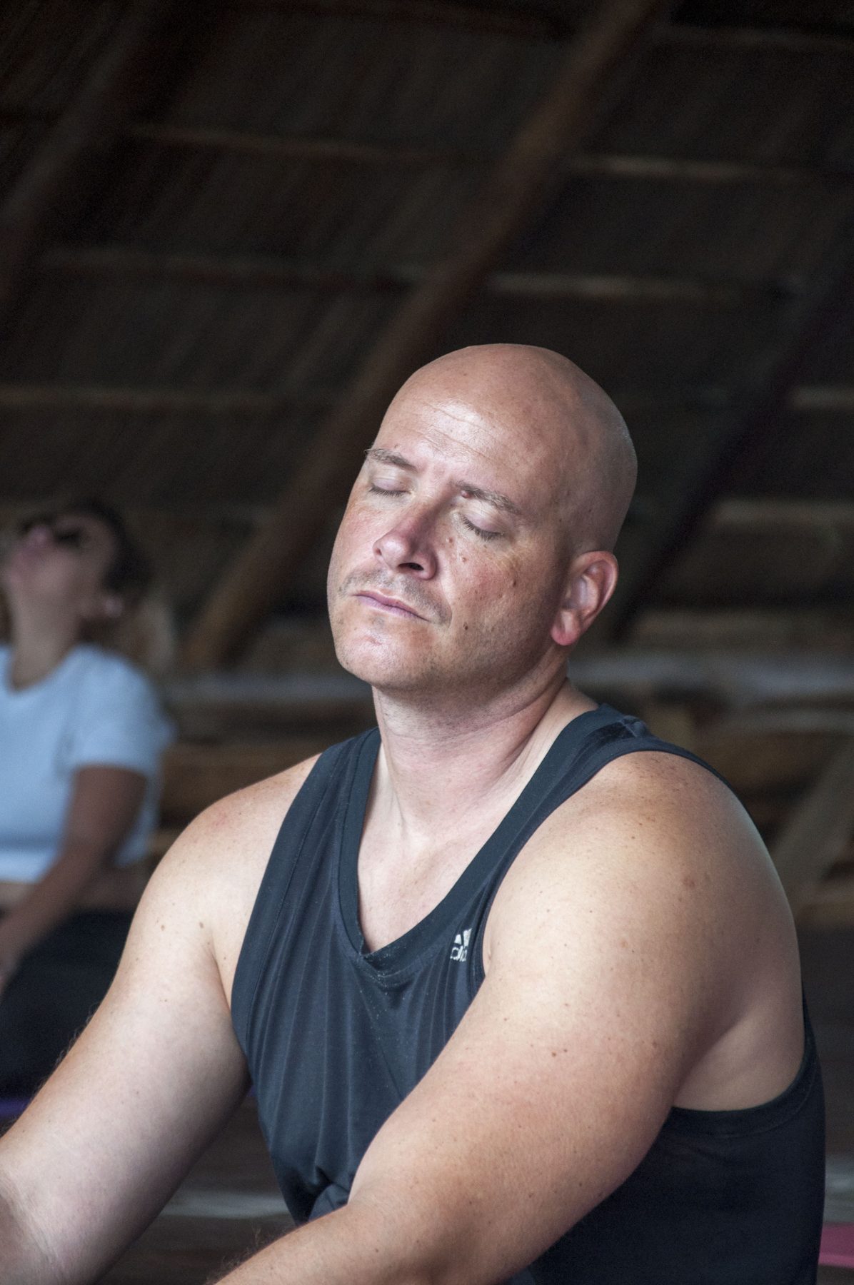 A guest sitting in meditation during an afternoon session